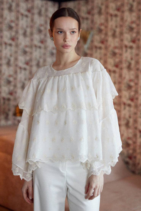 Embroidered voile white blouse with ruffles.