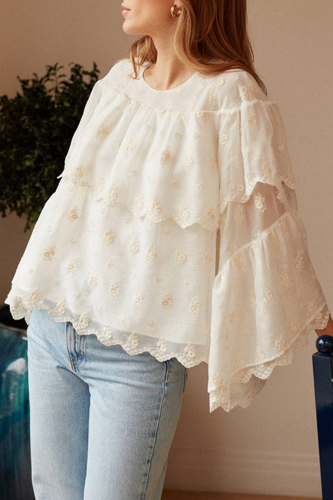 Embroidered voile white blouse with ruffles.